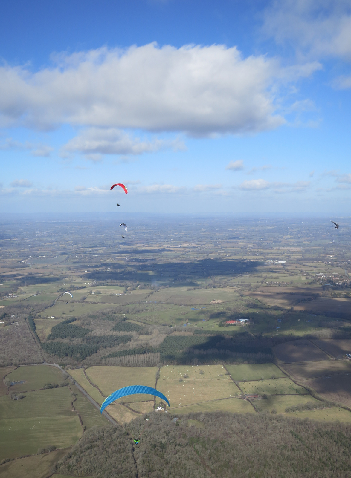 Gliding upwind from Newtimber towards Mark, Finn, Franco and Luke climbing.