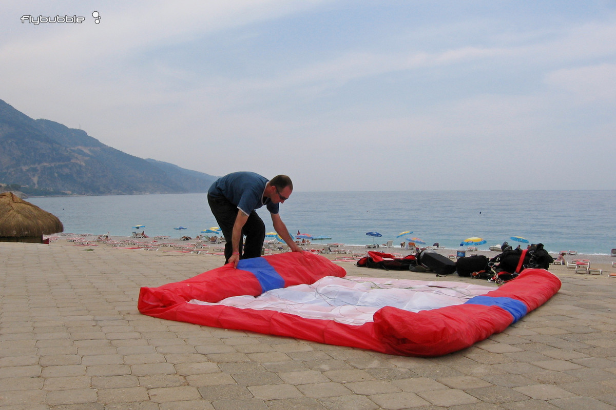 Paul packing up his paraglider on Oludeniz promenade after another great flight!