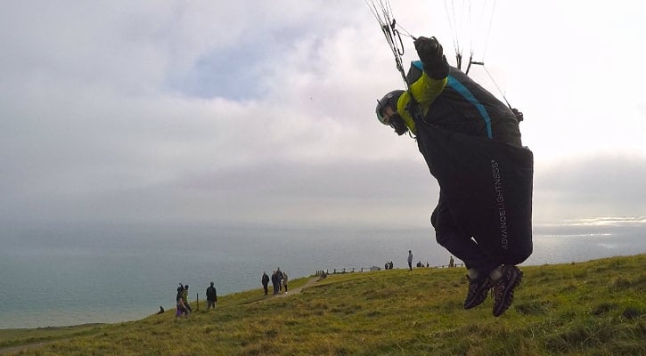 Paraglider pilot launches in pod harness